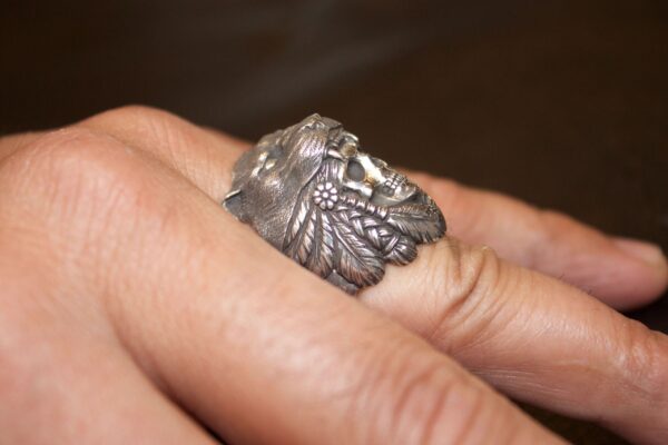 Silver ring shaped like a detailed eagle wrapped around a finger.