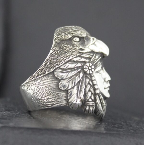 Silver ring with an eagle and Native American chief design.