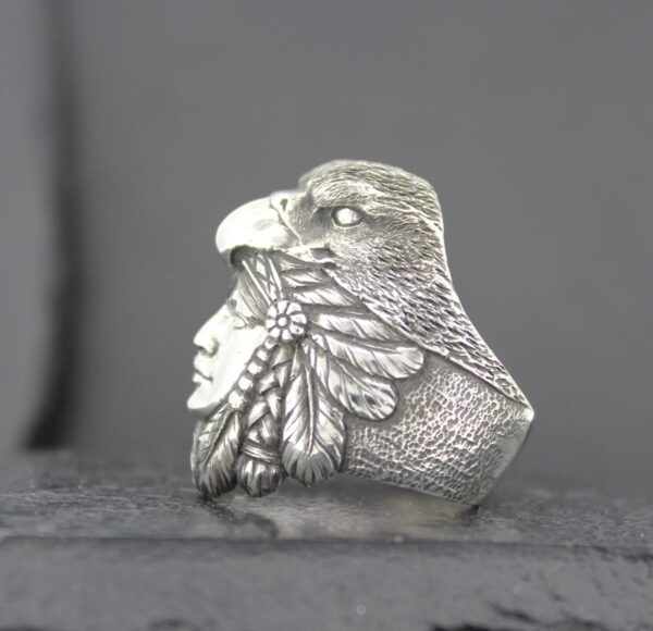 Intricate silver ring featuring a Native American profile and an eagle's head.