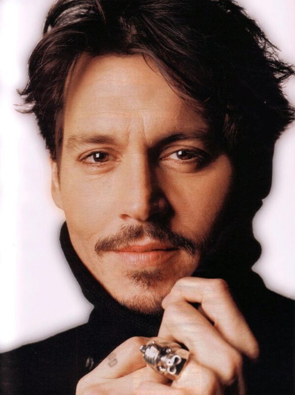 Close-up portrait of a man with a mustache and goatee.