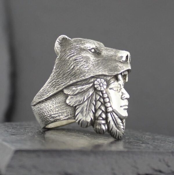 Silver ring featuring a Native American face with a bear headdress.