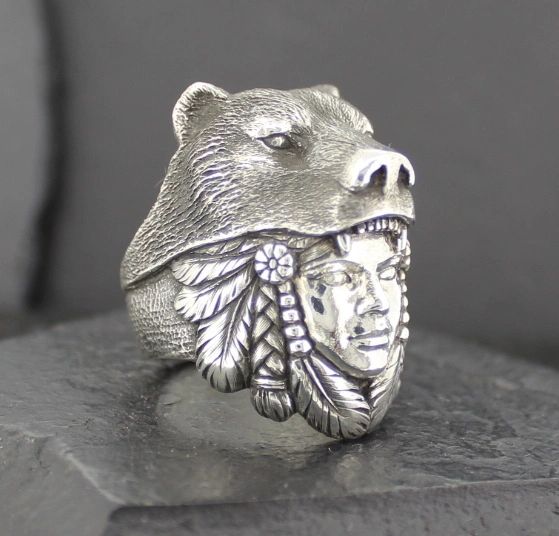 Intricately crafted silver ring featuring a bear and Native American chief design.
