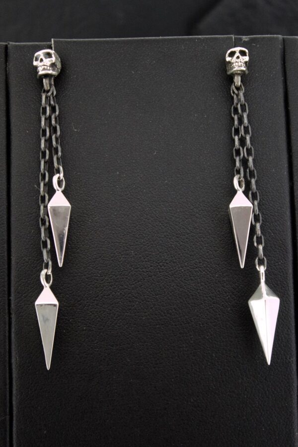 Silver pendant earrings with geometric shapes on black background.