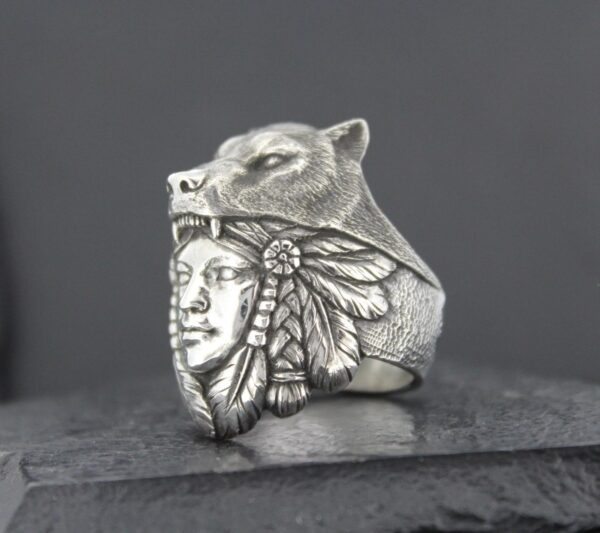 Silver ring featuring a Native American chief's face and a wolf's head.