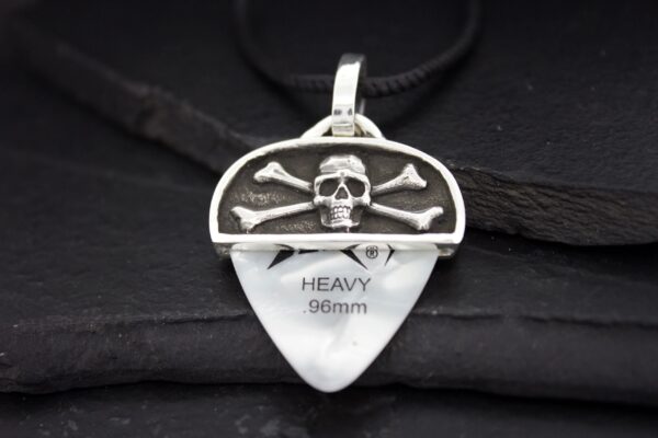 Silver skull and crossbones pendant on a guitar pick necklace.