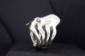A silver ring shaped like a hand with detailed fingers.