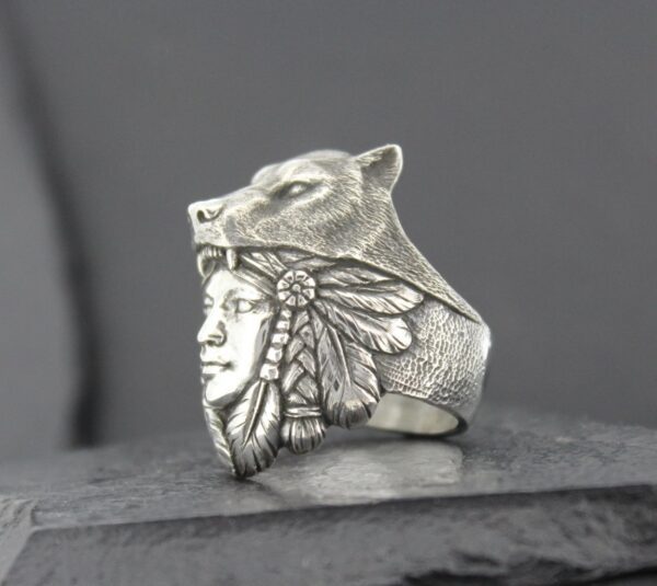 Silver ring featuring a Native American face with a wolf headdress.
