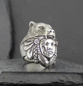 A silver ring featuring a bear head and a Native American chief face.