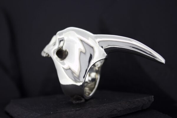 Sleek silver ring shaped like a panther head.