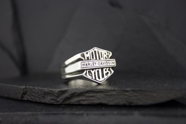 A sleek silver ring with 'AMOR' and 'KYLES' engraved on it.