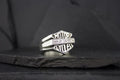 A sleek silver ring with 'AMOR' and 'KYLES' engraved on it.