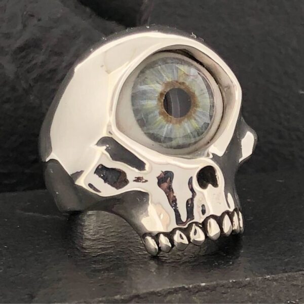 A ring shaped like a skull with a detailed eyeball on top.