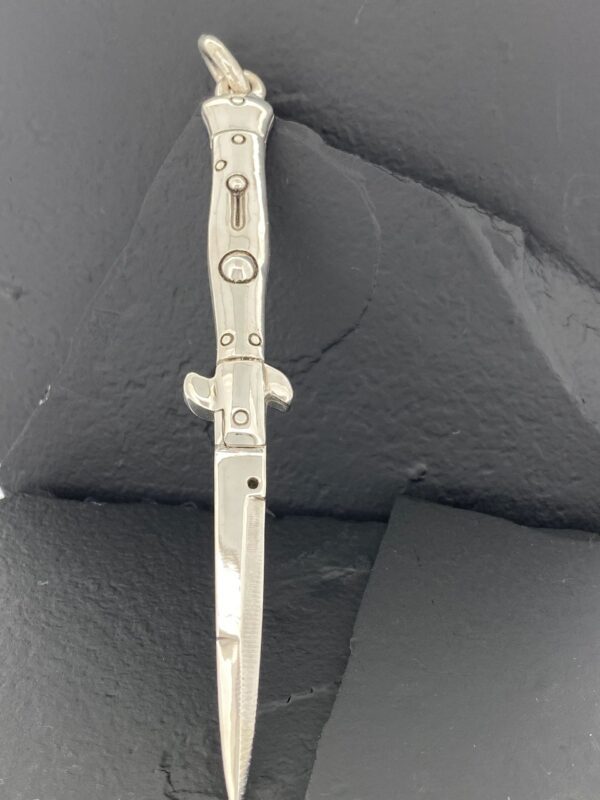 A close-up of a metallic dagger with a sleek, modern design.