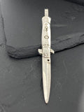 Vintage switchblade knife with a metallic handle and blade.