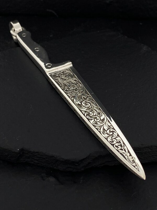 Ornate dagger with intricate floral engravings on the blade.