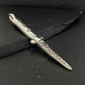 Silver dagger-shaped pendant with intricate detailing on a dark background.