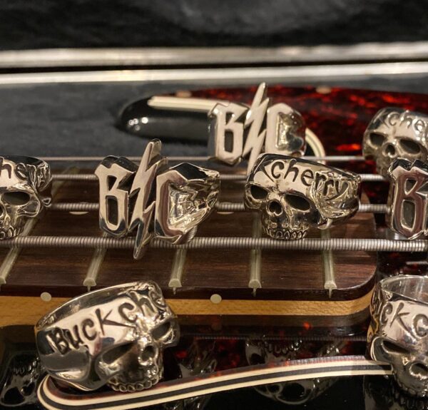 Close-up of silver lapel pins with various words and symbols.