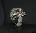 Intricately designed skull-shaped ring with detailed carvings.