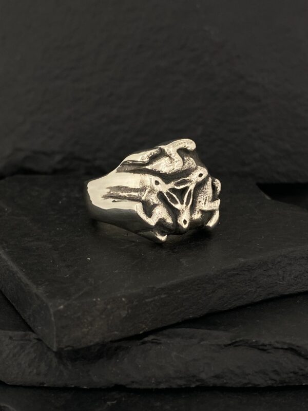 A silver ring with a detailed animal skull design.