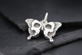 Close-up of a silver butterfly pendant with intricate design.