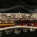 Close-up of a saxophone's intricate keys and skull decorations.
