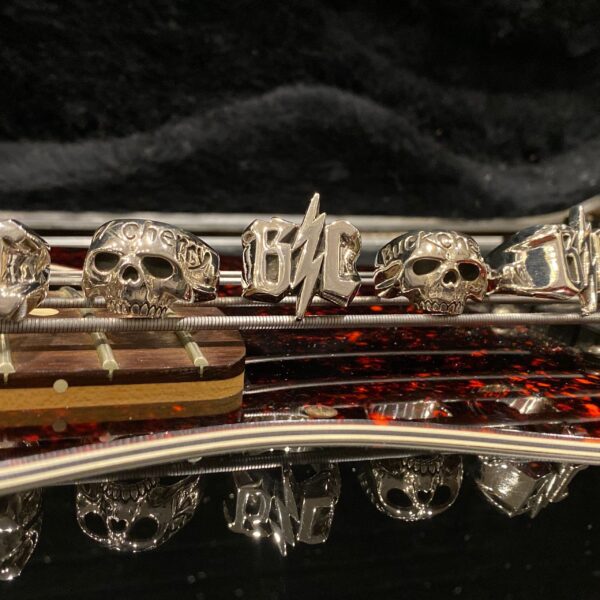 Close-up of a saxophone's intricate keys and skull decorations.