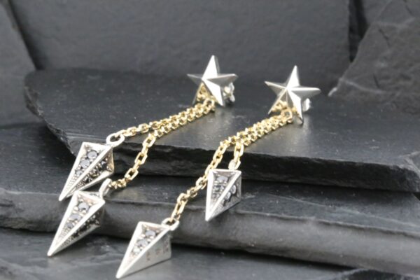 Elegant silver star and geometric drop earrings with delicate chains.