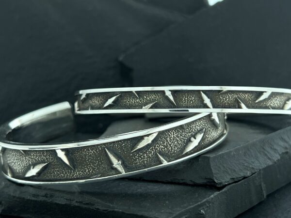 Close-up of metal tire chains with rugged tread pattern.