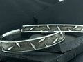 Close-up of metal tire chains with rugged tread pattern.