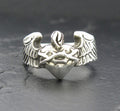 Silver ring with angel wings and a heart design.