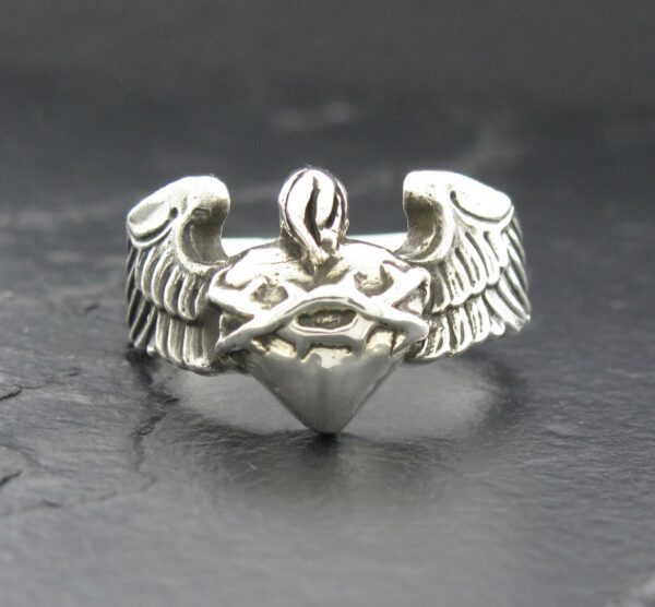 Silver ring with angel wings and a heart design.