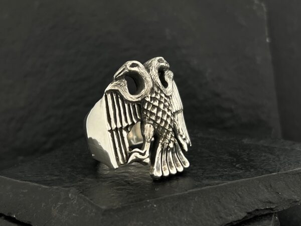 Silver owl-shaped ring with detailed wings and eyes.