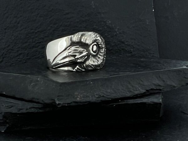 Silver ring featuring a detailed ram skull design.