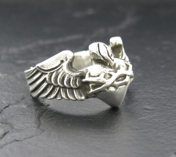 A silver ring shaped like a detailed eagle head with wings.