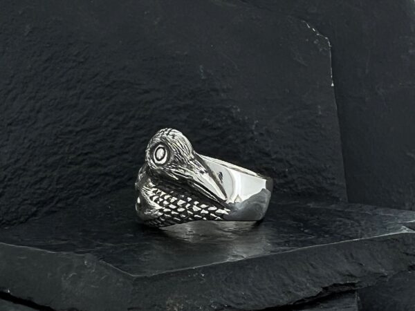 A silver ring designed as a crocodile head with detailed scales.