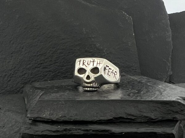 Silver skull ring engraved with "Truth" and "Fear".