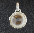 A round glass pendant with a silver frame on a black background.