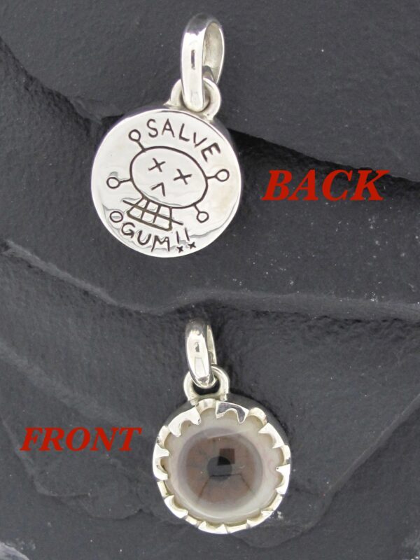Dual-sided silver pendant with engraved symbols and a central stone.