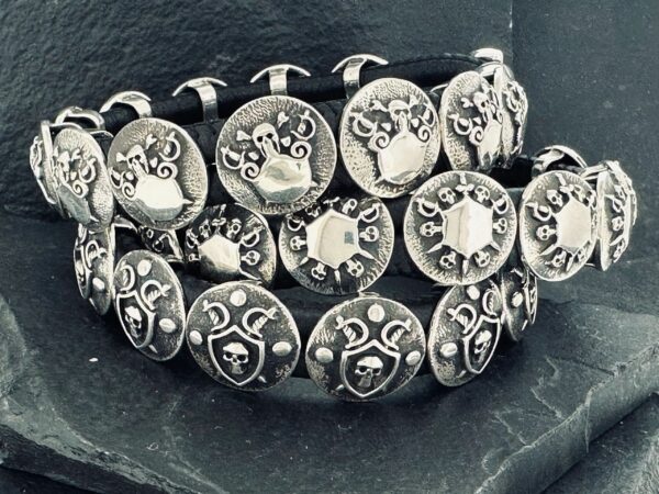 Close-up of intricately designed silver rings with ornate patterns.
