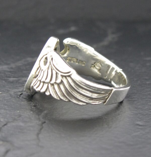 Silver ring featuring a detailed wing design.