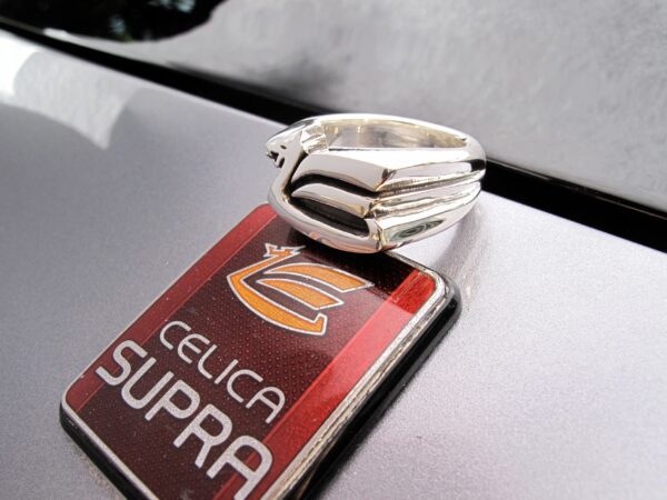 Close-up of a silver ring on a Celica Supra car keychain.