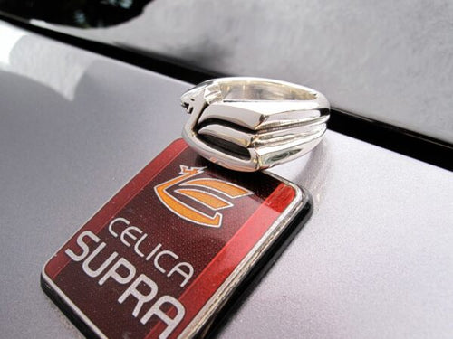 Close-up of a silver ring on a Celica Supra car keychain.