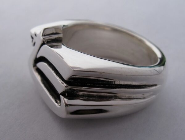 A sleek silver ring with a modern geometric design.