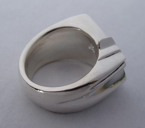 A sleek silver ring with a modern, geometric design.