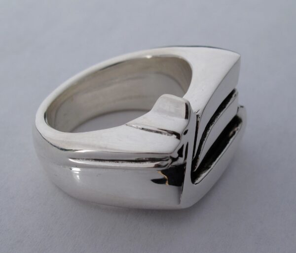A sleek silver ring with a modern geometric design.