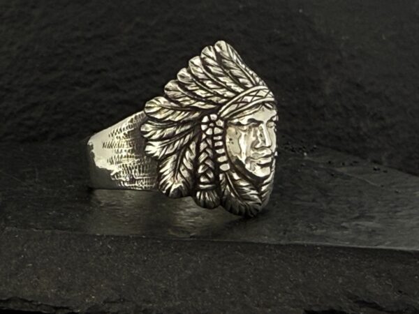 Silver ring engraved with a Native American chief wearing a feathered headdress.