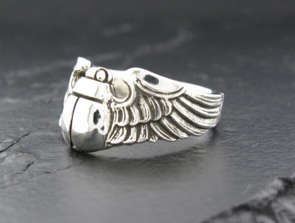 Silver ring with an intricate wing design.