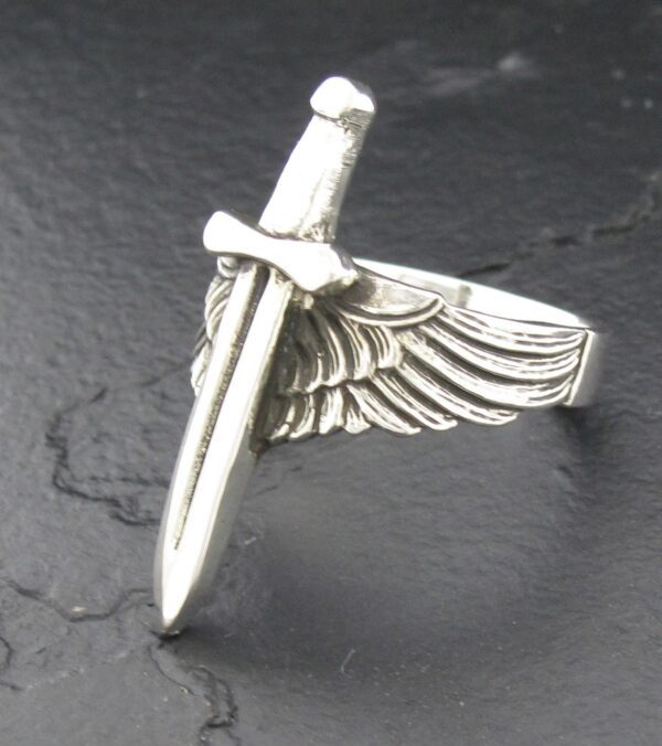 Silver ring featuring a sword and wing design.