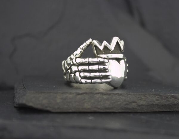Silver ring shaped like a skeletal hand.