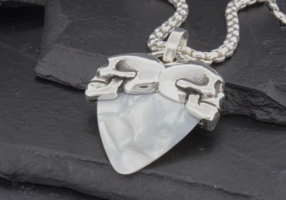Silver chain necklace with a white, uniquely shaped pendant.